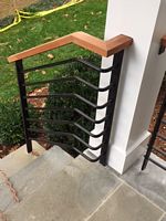 wood cap stair rail with round horizontal bars